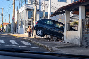 Carro Suspenso em Colisão Residencial